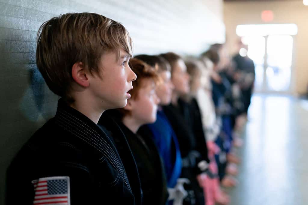 The Jiu Jitsu Institute students lined up watching instructor teach