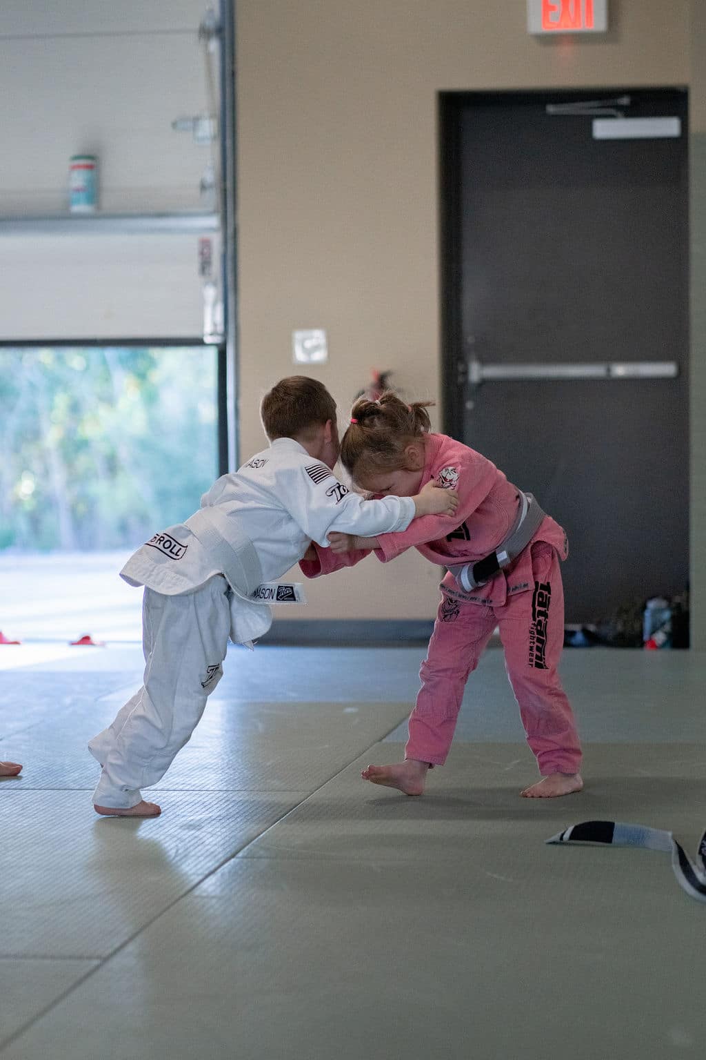 young girl and young boy sparring during jiu jitsu class at The Jiu Jitsu Institute