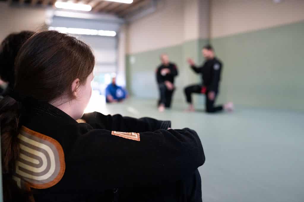 close up of The Jiu Jitsu Institute student watching instructor teach