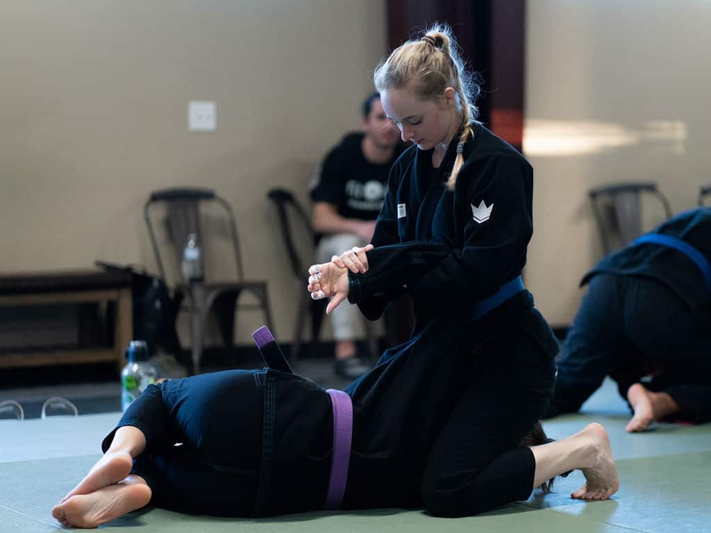 Proper holds demonstrated by two female jiu jitsu students at The Jiu Jitsu Institute