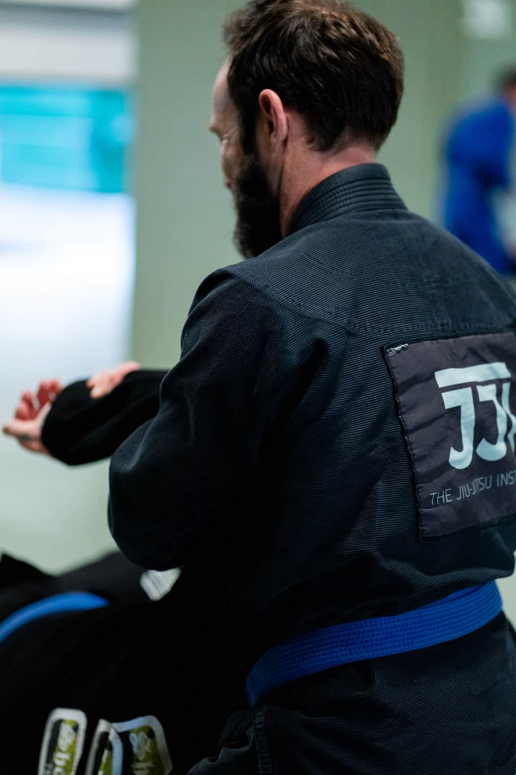 Jiu Jitsu Institute instructor demonstrating proper hold with student