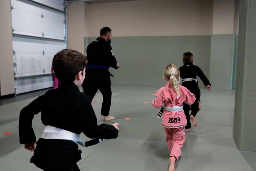 The Jiu Jitsu Institute young students running during jiu jitsu classes