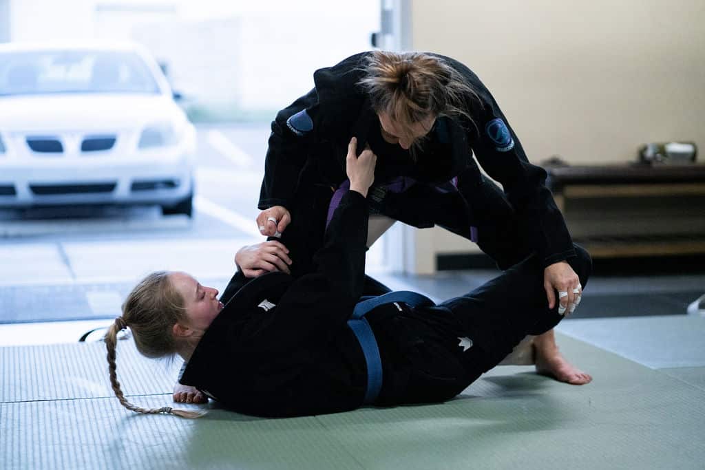 Two female adult The Jiu Jitsu Institute students sparring