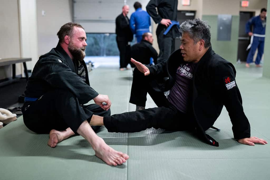 Two Jiu Jitsu Institute students chatting after jiu jitsu class